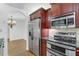 Kitchen boasts stainless steel appliances and rich wood cabinetry at 690 Osceola Ave # 209, Winter Park, FL 32789