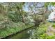 Peaceful waterfront pathway with lush landscaping and mature trees at 690 Osceola Ave # 209, Winter Park, FL 32789