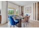 Bright dining room with glass table and access to a patio at 7101 Painted Bunting Way, St Cloud, FL 34773