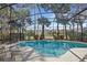 Enclosed pool and spa with lounge chairs, overlooking a lake at 729 Timberwilde Ave, Winter Springs, FL 32708