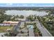 Aerial view of community featuring lake, pool, and numerous buildings at 734 E Michigan St # 113, Orlando, FL 32806