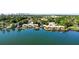 Aerial view shows the community condos along the lake with mature landscaping and downtown in the distance at 734 E Michigan St # 113, Orlando, FL 32806