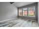 Bright bedroom with three windows and wood-look floors at 734 E Michigan St # 113, Orlando, FL 32806