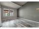 Spacious bedroom with wood-look floors and large windows at 734 E Michigan St # 113, Orlando, FL 32806