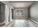 Bright bedroom with two windows, wood-look floors, and built-in shelves at 734 E Michigan St # 113, Orlando, FL 32806