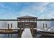 Exterior shot shows dock on lake with gazebo and boats for recreational use for residents at 734 E Michigan St # 113, Orlando, FL 32806