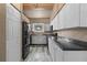 Modern kitchen with black appliances and dark countertops at 734 E Michigan St # 113, Orlando, FL 32806