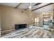 Living room with high ceilings, wood-look floors, and a view of the kitchen at 734 E Michigan St # 113, Orlando, FL 32806