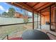 Screened patio with table and chairs overlooking backyard at 734 E Michigan St # 113, Orlando, FL 32806