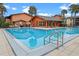 Community pool with adjacent clubhouse at 734 E Michigan St # 113, Orlando, FL 32806
