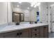 Elegant bathroom boasts dual sinks, quartz countertops, and a large mirror at 8137 Surf St, Kissimmee, FL 34747