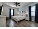 Spacious bedroom with a king-size bed and wood floors at 8137 Surf St, Kissimmee, FL 34747