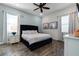 Bedroom with a navy velvet headboard bed and wood-look tile floors at 8137 Surf St, Kissimmee, FL 34747