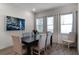Bright dining room features a dark wood table with six chairs and large windows at 8137 Surf St, Kissimmee, FL 34747