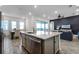Kitchen with island, stainless steel appliances, and dining area at 8137 Surf St, Kissimmee, FL 34747
