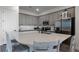 Modern kitchen with gray cabinets, stainless appliances and island at 8137 Surf St, Kissimmee, FL 34747