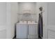 Bright laundry room with washer, dryer, and shelving at 8137 Surf St, Kissimmee, FL 34747
