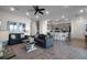 Open living room with gray couches and wood-look tile floors at 8137 Surf St, Kissimmee, FL 34747