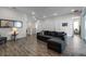 Spacious living area with gray sectional sofa and wood-look tile floors at 8137 Surf St, Kissimmee, FL 34747