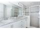Bathroom with double vanity, white cabinets and a large shower at 878 Galloway St, Lake Alfred, FL 33850