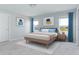 Main bedroom with light wood bed, blue accents, and large windows at 878 Galloway St, Lake Alfred, FL 33850