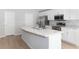 Modern kitchen with white cabinets, stainless steel appliances, and an island at 878 Galloway St, Lake Alfred, FL 33850