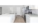Modern kitchen with white cabinets, stainless steel appliances, and an island at 878 Galloway St, Lake Alfred, FL 33850