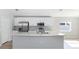 Modern kitchen with white cabinets, stainless steel appliances, and an island at 878 Galloway St, Lake Alfred, FL 33850