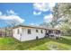 Backyard features lush green grass, fenced perimeter, and screened in porch at 8836 Ava Lake Dr, Orlando, FL 32810