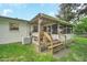 Backyard patio with a grill, wooden steps, and an air conditioning unit at 8836 Ava Lake Dr, Orlando, FL 32810