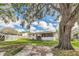 Backyard with shade tree, building, and covered patio at 8836 Ava Lake Dr, Orlando, FL 32810