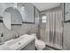 Modern bathroom featuring a stylish vanity, round mirror, and a shower with decorative curtain at 8836 Ava Lake Dr, Orlando, FL 32810