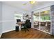 Bedroom with wood floors, a desk and an outside patio with sliding glass doors at 8836 Ava Lake Dr, Orlando, FL 32810