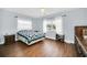 Comfortable bedroom with wood floors, large window, and ample closet space at 8836 Ava Lake Dr, Orlando, FL 32810