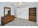 Bedroom with light blue walls, tiled floor, dresser, closet, and ceiling fan at 8836 Ava Lake Dr, Orlando, FL 32810