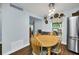 Bright dining area featuring wood floors, modern lighting, and views of the outdoor deck at 8836 Ava Lake Dr, Orlando, FL 32810