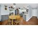 Dining area with a wooden table, chairs, and a view of the open-concept kitchen featuring stainless steel appliances at 8836 Ava Lake Dr, Orlando, FL 32810
