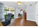 Dining room with wood floors, and sliding glass doors lead to the screened in patio at 8836 Ava Lake Dr, Orlando, FL 32810