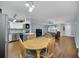 Open concept dining area with wood table, stainless steel appliances, and view into living space at 8836 Ava Lake Dr, Orlando, FL 32810