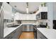 Modern kitchen with white upper cabinets, gray lower cabinets, stainless steel appliances, and quartz countertops at 8836 Ava Lake Dr, Orlando, FL 32810