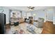 Bright living space with wood-look floors, ceiling fan, and comfortable seating at 8836 Ava Lake Dr, Orlando, FL 32810