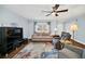 Comfortable living room setup with a cozy sofa, hardwood floors, a ceiling fan, and a view of the backyard at 8836 Ava Lake Dr, Orlando, FL 32810