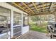 Enclosed screened porch with wood ceiling beams, access to a fenced back yard at 8836 Ava Lake Dr, Orlando, FL 32810