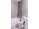 Clean bathroom with white toilet and grey tile at 8876 Finsen St, Orlando, FL 32827