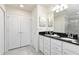 Double vanity bathroom with dark countertop and shower at 9009 Rhodes St, Kissimmee, FL 34747