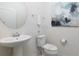 Small half bathroom with pedestal sink and toilet at 9009 Rhodes St, Kissimmee, FL 34747