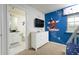Bedroom with a dresser, TV, and attached bathroom at 9009 Rhodes St, Kissimmee, FL 34747