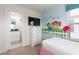 Bedroom with a twin bed, dresser, and view of en-suite bathroom at 9009 Rhodes St, Kissimmee, FL 34747