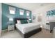 Main bedroom with a gray upholstered bed and teal accents at 9009 Rhodes St, Kissimmee, FL 34747
