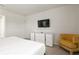 Comfortable bedroom with a dresser, TV, and accent chair at 9009 Rhodes St, Kissimmee, FL 34747